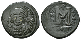 JUSTINIAN I (527-565). Follis.
Obv: D N IVSTINIANVS P P AVG.
Helmeted and cuirassed bust facing, holding globus cruciger and shield decorated with hor...