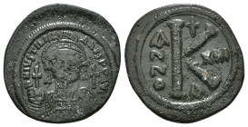 JUSTINIAN I (527-565). Follis.
Obv: D N IVSTINIANVS P P AVG.
Helmeted and cuirassed bust facing, holding globus cruciger and shield decorated with hor...