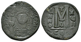 JUSTINIAN I (527-565). Follis.
Obv: D N IVSTINIANVS P P AVG.
Helmeted and cuirassed bust facing, holding globus cruciger and shield decorated with hor...