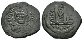 JUSTINIAN I (527-565). Follis.
Obv: D N IVSTINIANVS P P AVG.
Helmeted and cuirassed bust facing, holding globus cruciger and shield decorated with hor...