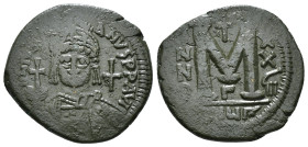 JUSTINIAN I (527-565). Follis.
Obv: D N IVSTINIANVS P P AVG.
Helmeted and cuirassed bust facing, holding globus cruciger and shield decorated with hor...