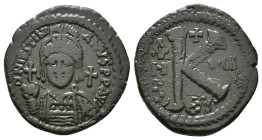 JUSTINIAN I (527-565). Follis.
Obv: D N IVSTINIANVS P P AVG.
Helmeted and cuirassed bust facing, holding globus cruciger and shield decorated with hor...