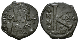 JUSTINIAN I (527-565). Follis.
Obv: D N IVSTINIANVS P P AVG.
Helmeted and cuirassed bust facing, holding globus cruciger and shield decorated with hor...