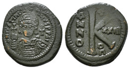 JUSTINIAN I (527-565). Follis.
Obv: D N IVSTINIANVS P P AVG.
Helmeted and cuirassed bust facing, holding globus cruciger and shield decorated with hor...