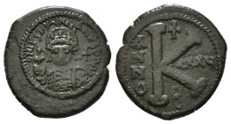 JUSTINIAN I (527-565). Follis.
Obv: D N IVSTINIANVS P P AVG.
Helmeted and cuirassed bust facing, holding globus cruciger and shield decorated with hor...