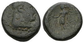 LYDIA, Sardes. Circa 133 BC-AD 14. Æ. Laureate head of youthful Herakles right, lion skin tied around neck / Apollo standing left, holding crow and la...