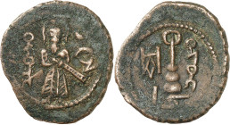 Arab-Byzantine coins, Temp. of ‘Abd al-Malik ibn Marwân, 65-70 H./685-705 AD.

AE Fals of standing caliph type, Harrân. The caliph (or the prophet Muh...