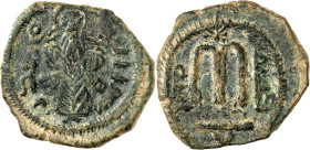 Arab-Byzantine coins, Temp. of ‘Abd al-Malik ibn Marwân, 65-70 H./685-705 AD.

AE Fals of standing caliph type, Filastîn. The caliph with whip hanging...