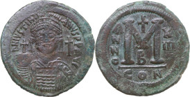 Justinian I (527-565). AE Follis, Constantinople mint, dated RY 13 (539-540). Obv. Helmeted and cuirassed bust facing, holding globus cruciger and shi...