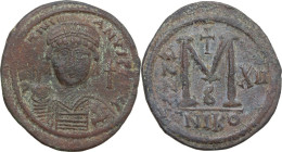 Justinian I (527-565). AE Follis, Nicomedia mint, dated RY 12 (538-539). Obv. Helmeted and cuirassed bust facing, holding globus cruciger and shield; ...