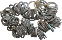 BRONZE RING NECKLACE Celtic World, 1st millennium BC. Ring necklace made of of 94 bronze rings. Lenght: c. 180 mm. Weight: 107 g. Rare and interesting...
