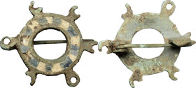 ROMAN ENAMELLED DISC FIBULA Roman period, c. 2nd century AD. Roman bronze fibula in the shape of a disc. Decoration in blue glass paste and bone (?). ...