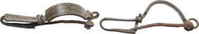 ROMAN BRONZE FIBULA Roman period, c. 1st - 3rd century AD. Bronze fibula with engraved decoration. Lenght: 69 mm. Solid brown patina. Slightly bent, d...