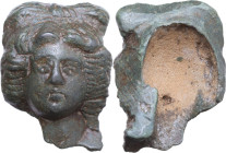 FEMALE BRONZE HEAD Roman period, c. 1st - 3rd century AD (?). Bronze female frontal head with complex hair. Niche in the back. Dimensions: 41 x 31 mm....