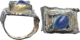 GILDED BRONZE RING Early Middle Age, c. 5th - 10th century AD. Gilded bronze ring with blue glass paste bezel. Size: 16.5 mm.