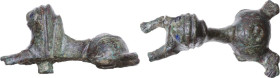 LION STATUETTE Barbaric to Medieval period, c. 6th to 12th century AD. Bronze statuette in the shape of a supine lion, with eyes made of glass paste. ...
