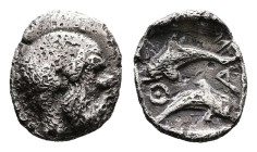 Islands off Thrace, Thasos, circa 412-404 BC. AR Tritartemorion ( 7mm, 0,41 g.). Bald and bearded head of satyr to right. Rev. ΘΑΣ Two dolphins, one a...