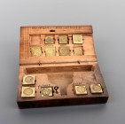 Boîte de changeur comprenant 12 poids monétaires.
Boîte inscrite comprenant les noms des monnaies en hollandais.
Les poids de cette boîte ont une orig...