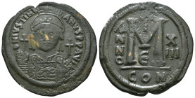 JUSTINIAN I (527-565). Follis.
Obv: D N IVSTINIANVS P P AVG.
Helmeted and cuirassed bust facing, holding globus cruciger and shield decorated with hor...