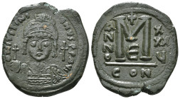 JUSTINIAN I (527-565). Follis.
Obv: D N IVSTINIANVS P P AVG.
Helmeted and cuirassed bust facing, holding globus cruciger and shield decorated with hor...
