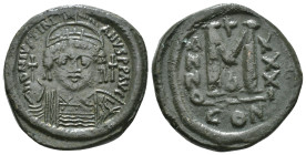 JUSTINIAN I (527-565). Follis.
Obv: D N IVSTINIANVS P P AVG.
Helmeted and cuirassed bust facing, holding globus cruciger and shield decorated with hor...