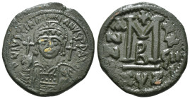 JUSTINIAN I (527-565). Follis.
Obv: D N IVSTINIANVS P P AVG.
Helmeted and cuirassed bust facing, holding globus cruciger and shield decorated with hor...