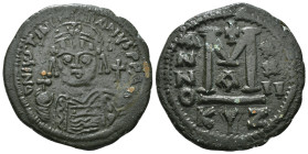 JUSTINIAN I (527-565). Follis.
Obv: D N IVSTINIANVS P P AVG.
Helmeted and cuirassed bust facing, holding globus cruciger and shield decorated with hor...