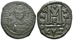 JUSTINIAN I (527-565). Follis.
Obv: D N IVSTINIANVS P P AVG.
Helmeted and cuirassed bust facing, holding globus cruciger and shield decorated with hor...