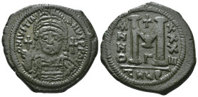 JUSTINIAN I (527-565). Follis.
Obv: D N IVSTINIANVS P P AVG.
Helmeted and cuirassed bust facing, holding globus cruciger and shield decorated with hor...