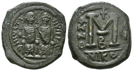 JUSTIN II, with SOPHIA (565-578). Follis.
Obv: D N IVSTINVS PP AVG.
Justin and Sophia seated facing on double throne, holding globus cruciger and cruc...