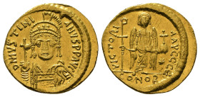 JUSTINIAN I (527-565). GOLD Solidus. Constantinople.
Obv: D N IVSTINIANVS P P AVG.
Helmeted and cuirassed bust facing, holding globus cruciger and shi...