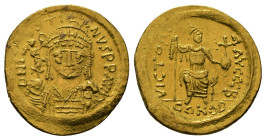 JUSTINIAN I (527-565). GOLD Solidus. Constantinople.
Obv: D N IVSTINVS P F AVG.
Helmeted and cuirassed bust facing, holding globus cruciger and shield...