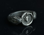 Serpent formed ring with an silver detailed Hellios.
11,37 g - 25,52 mm
