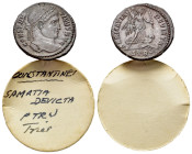 Constantine I (307/310-337). Æ Follis (19mm, 3.26g).Treveri, 323-4. Laureate head r. R/ Victory advancing r., holding trophy and palm, spurning captiv...