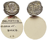 Delmatius (Caesar, 335-337). Æ Follis (17mm, 1.56g). Cyzicus, 336-7. Laureate and cuirassed bust r. R/ Two soldiers standing facing one another, each ...