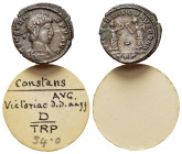 Constans (337-350). Æ (15mm, 1.53g). Treveri, 347-8. Diademed, draped and cuirassed bust r. R/ Two Victories standing facing one another, each holding...