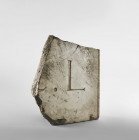 A large marble fragment of a plaque with inscription preserving a dot and the letter L. Roman Imperial Period, 1st - 3rd century AD. Excellent workman...