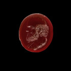 Gemstone with the portrait of Socrates. Roman, 2nd half 1st century BC. 1,5 x 1,3cm. Oval intaglio made of dark orange cornelian with plain back. On t...