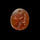 Gemstone with Silenus as actor. Late Roman Republic, 1st century BC. 1,3 x 1,1cm. Oval intaglio made of orange cornelian with plain back. On the sligh...