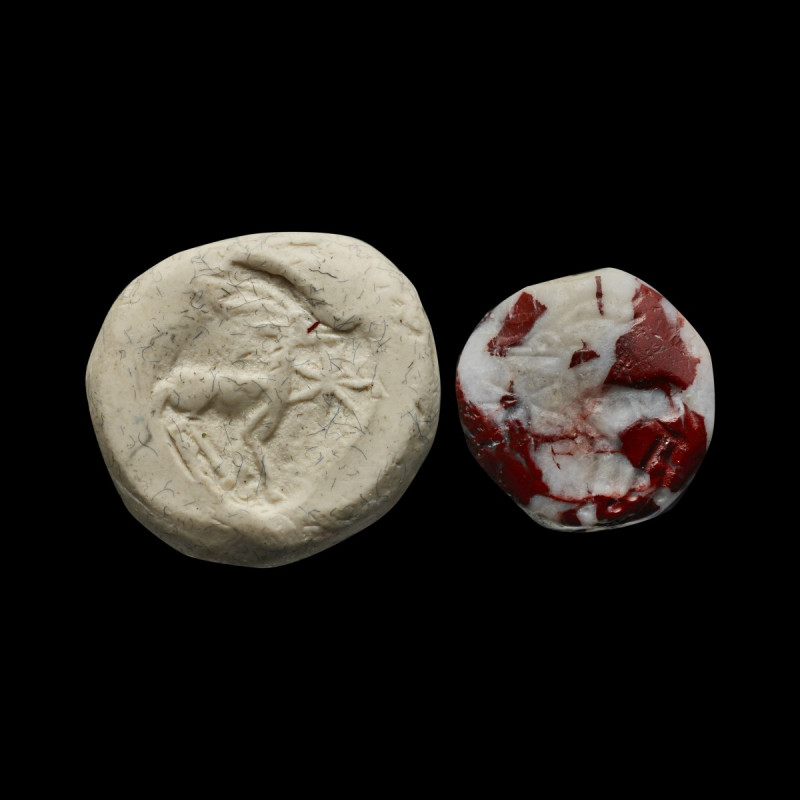 A Greek(?) lentoid stone, red-white breccia, with a goat and a star. 8th / 7th c...