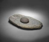 Neolithic grinding mill of roughly rectangular form made from light grey stone with white enclosures. Length 43,5cm, width 25,4cm, height 6,4cm. With ...