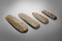 Four extremly rare Neolithic macrolithic objects from the Sahara. Length 17,8cm, 19,3cm, 25,8cm and 27,4cm. Light grey chert. Because of a bending in ...