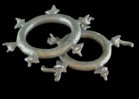 Two large bronze rings (ø 14 and 15cm) with stylized animal heads on the outside, one with six horned heads the other with five horned heads with bird...