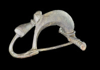 Celtiberian bronze cast fibula of the type turret fibula , the elongated foot is bent back and ends in a stylized human head. 4th - 2nd century BC. Gr...