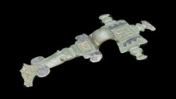 Bronze long brooch, the rectangular head-plate with three stylised bird's head, remains of gilding and zig-zag-decor in niello, with arched bow, the f...