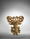 Magdalena, Northern Colombia, 1200 AD. H 10cm, W 9cm. Gold figure of a standing shaman wearing a crown consisting of two bird figures, in the back a f...