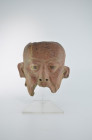 Remojadas, 200 - 500 AD. H 16.5cm. Terracotta with reddish-brown paint, black pupils made of Chapopote clay. Very impressive fragment of a male head, ...