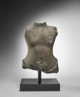 Torso of a Khmer statue. Angkor Borei or Prakho Chan, 7th - 9th century A.D. L 36cm, W 27cm. Dark grey sandstone. Unadorned torso, presumably of the B...