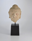 Head of Buddha, Gandhara region (Hadda), about 3rd century AD. H 12cm (without stand), H 22cm (with stand). Stucco with traces of red painting. Broken...