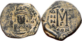 Maurice Tiberius (582-602) Follis. Obverse: Helmeted and cuirassed bust facing, holding globus cruciger and shield., Reverse: Large M above cross, ANN...